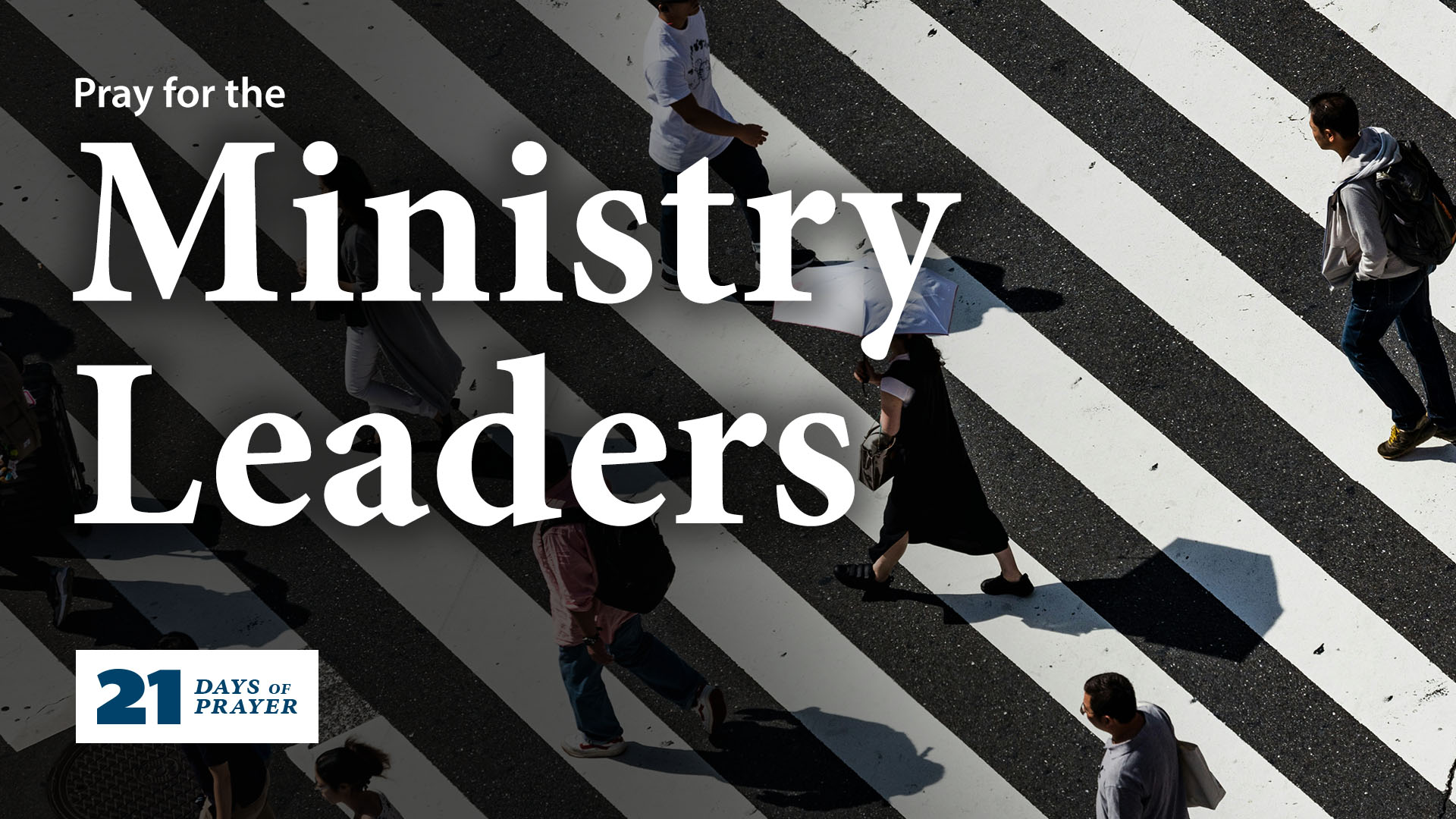 An aerial view of a busy crosswalk with people crossing. The text says 