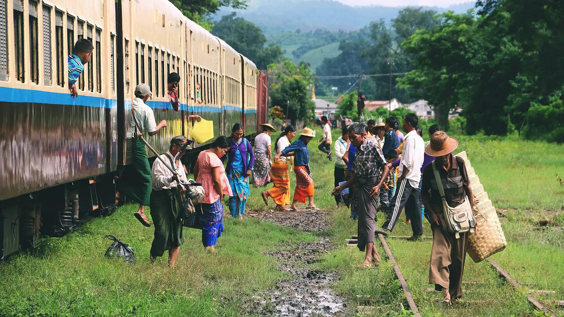 A group of people boarding a train in Myanmar
