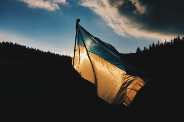 Flag of Ukraine with sun setting
