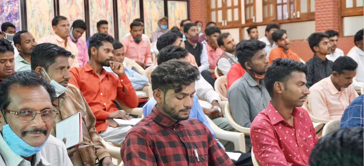 South Asians in a training centre, learning scripture.