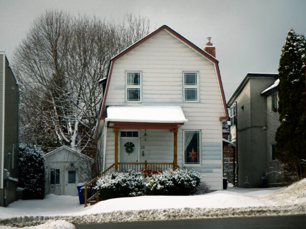 picturesque small city home with snow on the ground