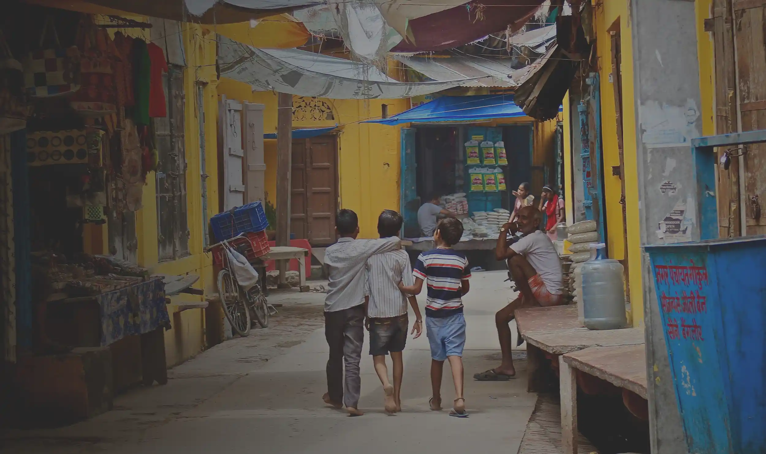 Three kids walking down the street in South Asia